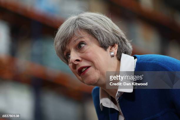 British Prime Minister Theresa May speaks to employees at a ScrewFix distribution centre on May 16, 2017 in Stoke On Trent, United Kingdom. Britain...