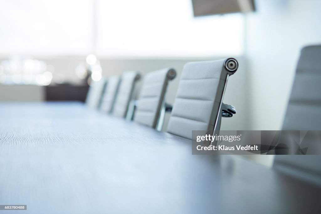 Row of empty chairs in board room