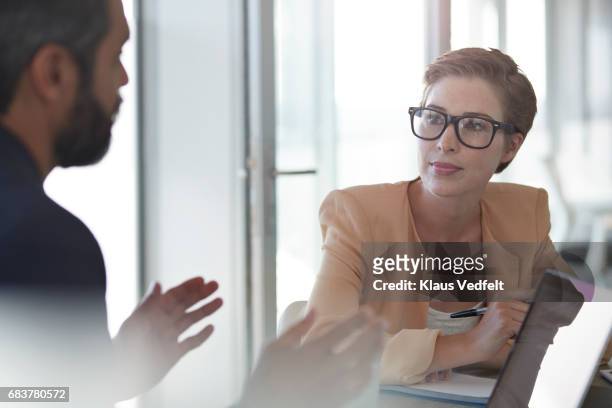 co-workers talking together at office space - soft focus office stock pictures, royalty-free photos & images