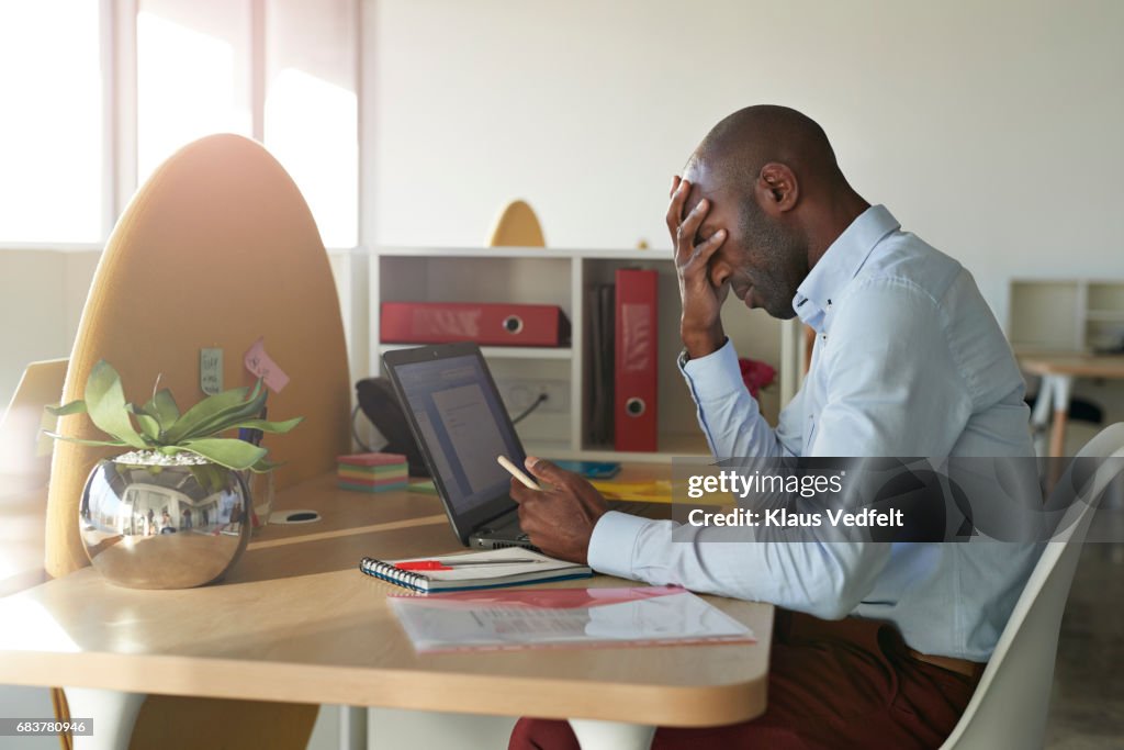 Businessman sitting at office desk