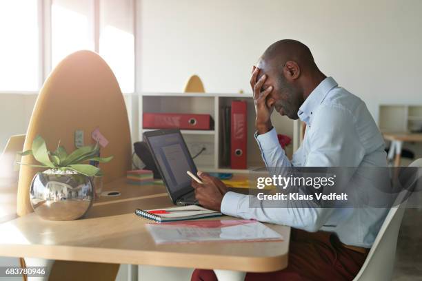 businessman sitting at office desk - head in hands computer stock pictures, royalty-free photos & images