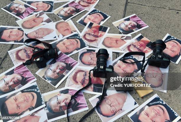 Cameras and pictures of journalists recently murdered in different Mexican states are placed at Independence Angel square during a protest by...