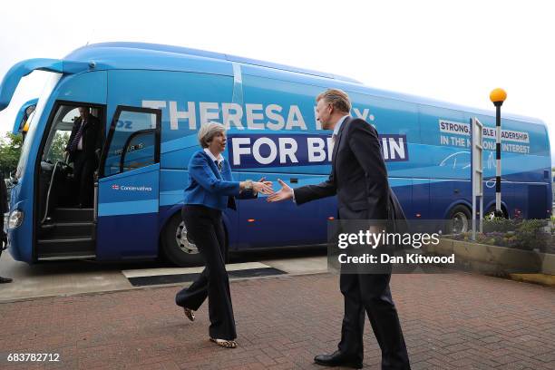 British Prime Minister Theresa May is greeted by Screwfix CEO Andrew Livingston as she arrives to speak to employees at a ScrewFix distribution...