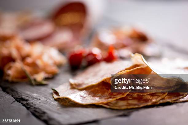 cured meats charcuterie on a slate tray - fresh meat film stock pictures, royalty-free photos & images