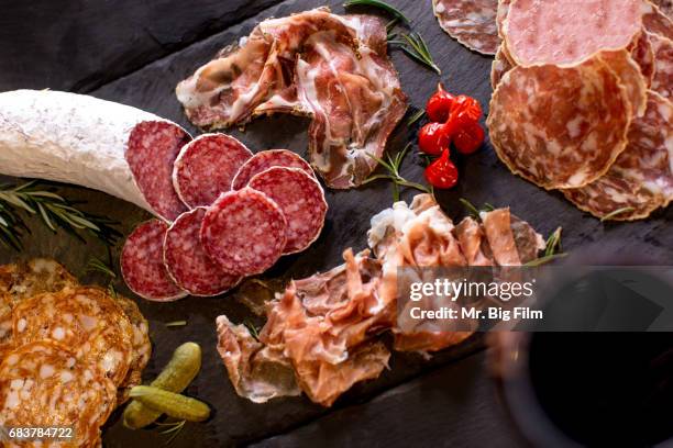 cured meats charcuterie on a slate tray - fresh meat film stock pictures, royalty-free photos & images