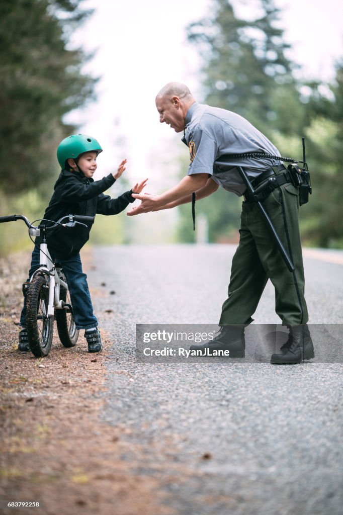 Police Officer Talking to Child on Bike