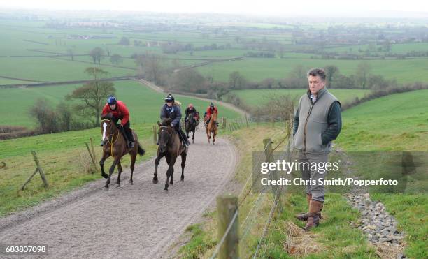 Racehorses Kauto Star and Denman training on the gallops near Ditcheat, with the Somerset levels beyond, under the watchful eye of their trainer Paul...