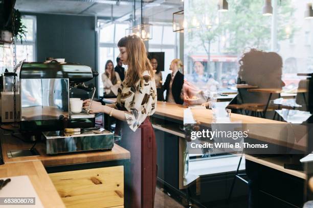 waitress preparing coffee at business cafe counter - bar berlin stock pictures, royalty-free photos & images