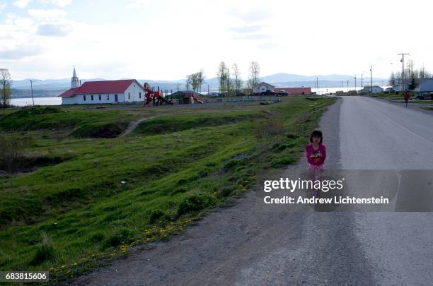 Young First Nation walks down a street on April 25, 2016 in the small community of Taiche, British Columbia. Three years after 26 year old Mackie...