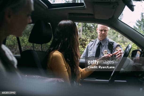 police officer making traffic stop - police car lights stock pictures, royalty-free photos & images