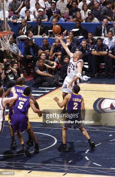 Jason Kidd of the New Jersey Nets drives to the basket against Derek Fisher of the Los Angeles Lakers during game 3 of the 2002 NBA Finals at the...