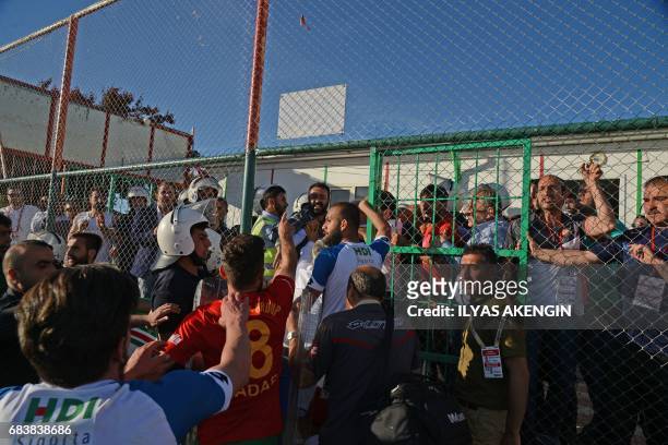 Turkish anti-riot police officers guard Erzurum's players on May 16, 2017 after they won the Turkish Super Lig white group semi-final second leg...