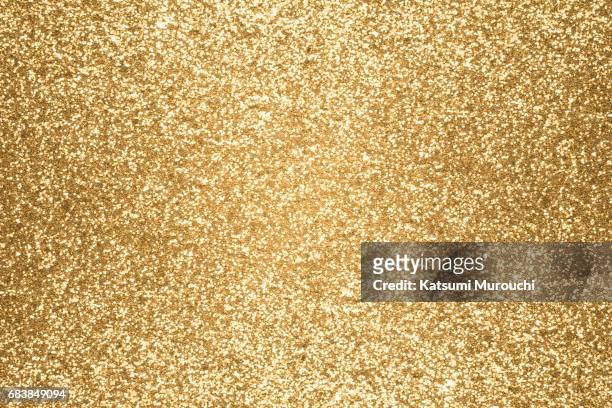 golden glitter textures background - gold coloured stock pictures, royalty-free photos & images