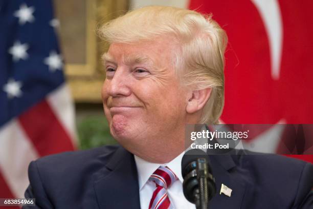 President Donald Trump smiles during a joint statement with President of Turkey Recep Tayyip Erdogan in the Roosevelt Room of the White House on May...