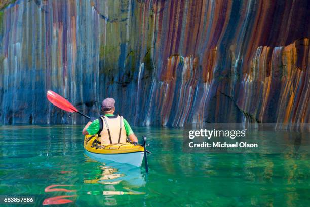 im bild rocks kayaker colored cliff - seen great lakes stock-fotos und bilder