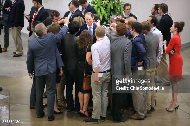 Reporters surround Sen. Ron Wyden as he heads for his party's weekly policy luncheon at the U.S. Capitol May 16, 2017 in Washington, DC. Many...