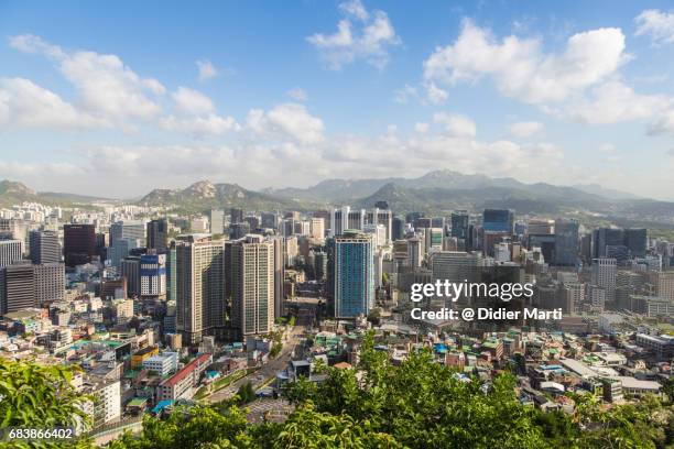 view on seoul business district skyline from namsan in south korea - korea city stockfoto's en -beelden