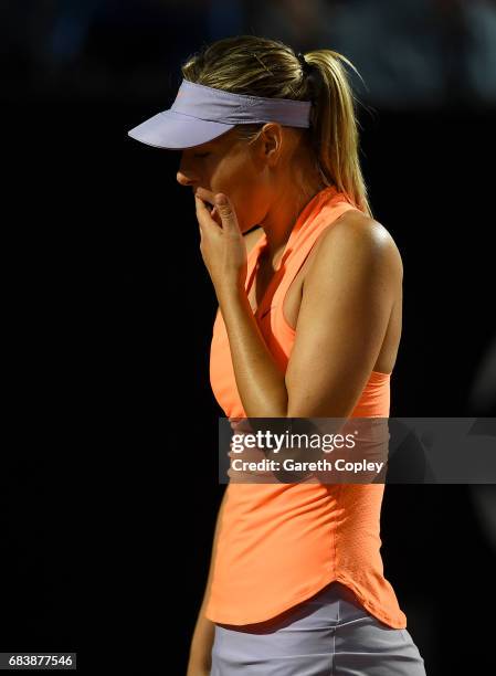 Maria Sharapova of Russia reacts after pulling up with an injury during her second round match against Miriana Lucic-Baroni of Croatia in The...