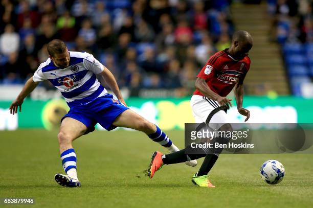 Sone Aluko of Fulham is tackled by Joey van den Berg of Reading during the Sky Bet Championship Play Off Second Leg match between Reading and Fulham...