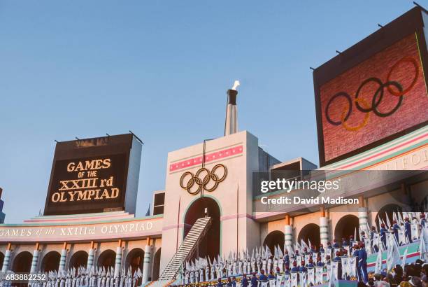 Rafer Johnson of the USA lights the Olympic Flame during the Opening Ceremony of the 1984 Summer Olympics at the Los Angeles Memorial Coliseum on...