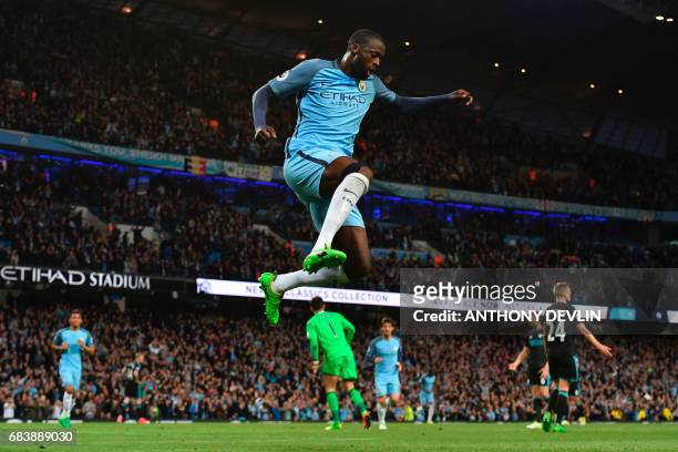 Manchester City's Ivorian midfielder Yaya Toure celebrates scoring their third goal during the English Premier League football match between...