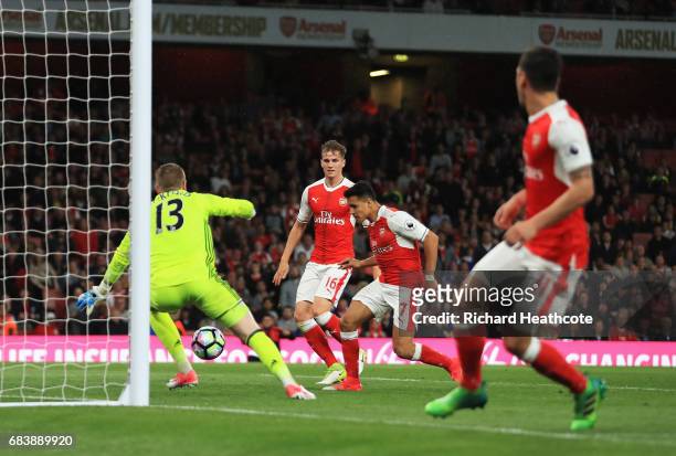 Alexis Sanchez of Arsenal scores his sides first goal past Jordan Pickford of Sunderland during the Premier League match between Arsenal and...