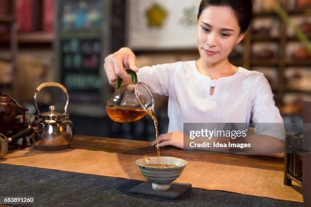 tea room owner serving tea - 中国茶 ストックフォトと画像