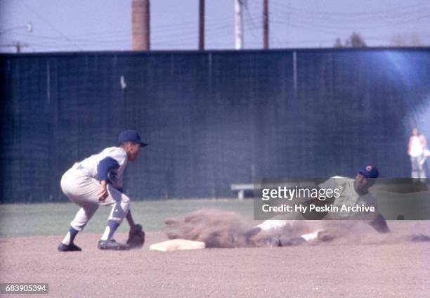 Maury Wills of the Los Angeles Dodgers looks to put a tag on an unidentified Chicago Cubs player during an MLB game circa April, 1962.