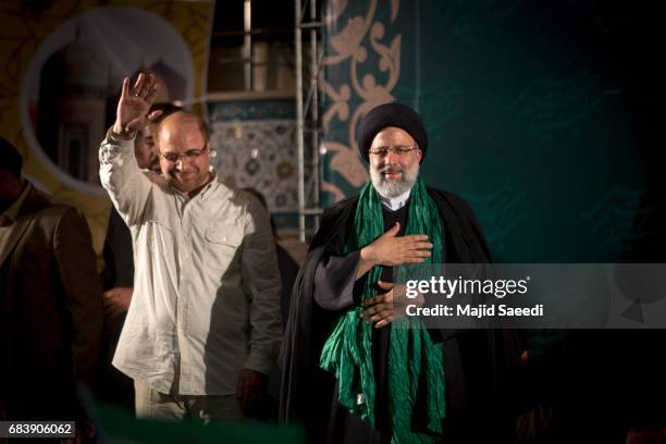 Iranian presidential candidate Ebrahim Raisi holds hands with former presidential candidate and mayor of Tehran, Mohammad Bagher Ghalibaf , as he...