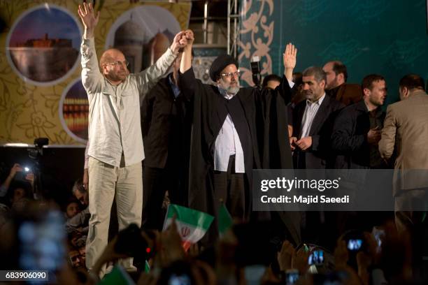 Iranian presidential candidate Ebrahim Raisi holds hands with former presidential candidate and mayor of Tehran, Mohammad Bagher Ghalibaf , as he...