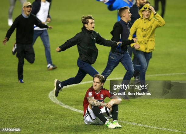 Stefan Johansen of Fulham looks dejected as Reading fans invade the pitch in celebration after the Sky Bet Championship Play Off Second Leg match...