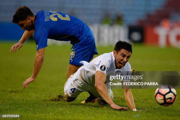 Jorge Fucile of Uruguay's Nacional and Luciano Guaycochea of Venezuela's Zulia fall during their Copa Libertadores football match at the Pachencho...