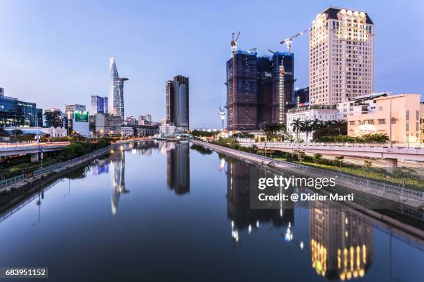 stunning reflection of skyscrapers in ho chi minh city in vietnam - modern vietnam stock pictures, royalty-free photos & images