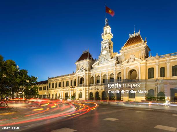 traffic light trails in front of the people's comittee building in ho chi minh city - newly industrialized country stock pictures, royalty-free photos & images