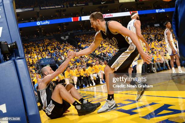 David Lee of the San Antonio Spurs helps up Manu Ginobili of the San Antonio Spurs during the game against the Golden State Warriors during Game Two...