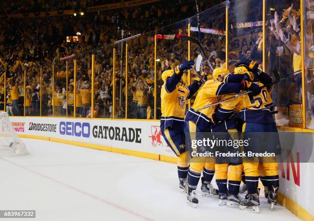 Roman Josi of the Nashville Predators celebrates with teammates after scoring a goal against John Gibson of the Anaheim Ducks during the third period...