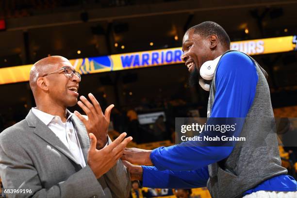 Kevin Durant of the Golden State Warriors talks with retired NBA player Monty Williams before the game against the San Antonio Spurs during Game Two...