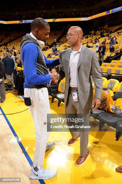 Kevin Durant of the Golden State Warriors talks with retired NBA player Monty Williams before the game against the San Antonio Spurs during Game Two...