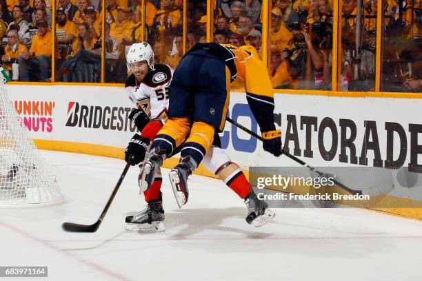 Shea Theodore of the Anaheim Ducks checks Austin Watson of the Nashville Predators during the third period in Game Three of the Western Conference...