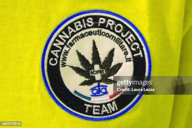 Logo of the Cannabis Project is displayed on the shirt of a grower employee in a greenhouse at the Italian Army at Stabilimento Chimico Farmaceutico...