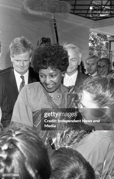 Winnie Mandela is greeted by childern on her arrival at the Berkley Court Hotel, . .