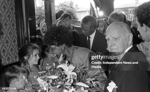 Winnie Mandela is greeted by childern on her arrival at the Berkley Court Hotel, . .