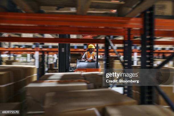 An employee operates a forklift at a warehouse operated by Future Supply Chain Solutions Ltd. Near the Multi-modal International Cargo Hub Airport at...