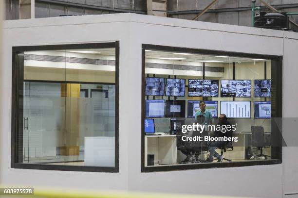 Employees sit inside a control room at a warehouse operated by Future Supply Chain Solutions Ltd. Near the Multi-modal Cargo International Hub...