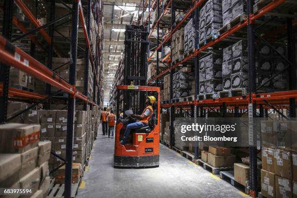 An employee operates a forklift at a warehouse operated by Future Supply Chain Solutions Ltd. Near the Multi-modal Cargo International Hub Airport at...