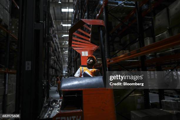 An employee operates a forklift at a warehouse operated by Future Supply Chain Solutions Ltd. Near the Multi-modal Cargo International Hub Airport at...