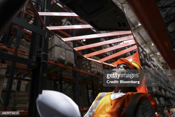 An employee operates a forklift at a warehouse operated by Future Supply Chain Solutions Ltd. Near the Multi-modal Cargo International Hub Airport at...