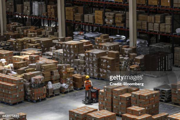An employee operates a forklift at a warehouse operated by Future Supply Chain Solutions Ltd. Near the Multi-modal Cargo International Hub Airport at...