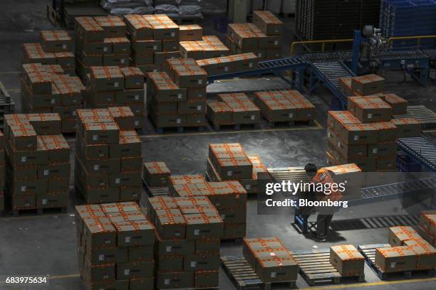 An employee lifts a box at a warehouse operated by Future Supply Chain Solutions Ltd. Near the Multi-modal Cargo International Hub Airport at Nagpur...