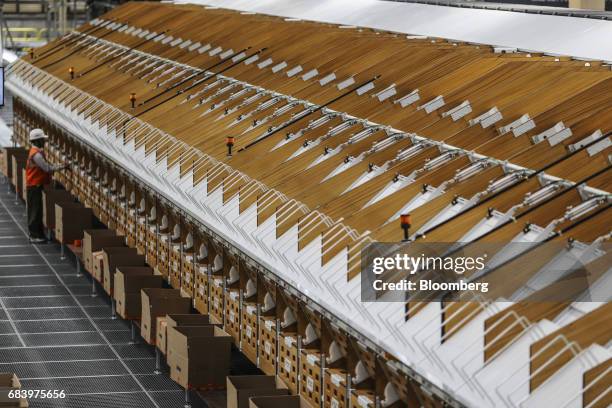 An employee loads merchandise into boxes at a warehouse operated by Future Supply Chain Solutions Ltd. Near the Multi-modal Cargo International Hub...